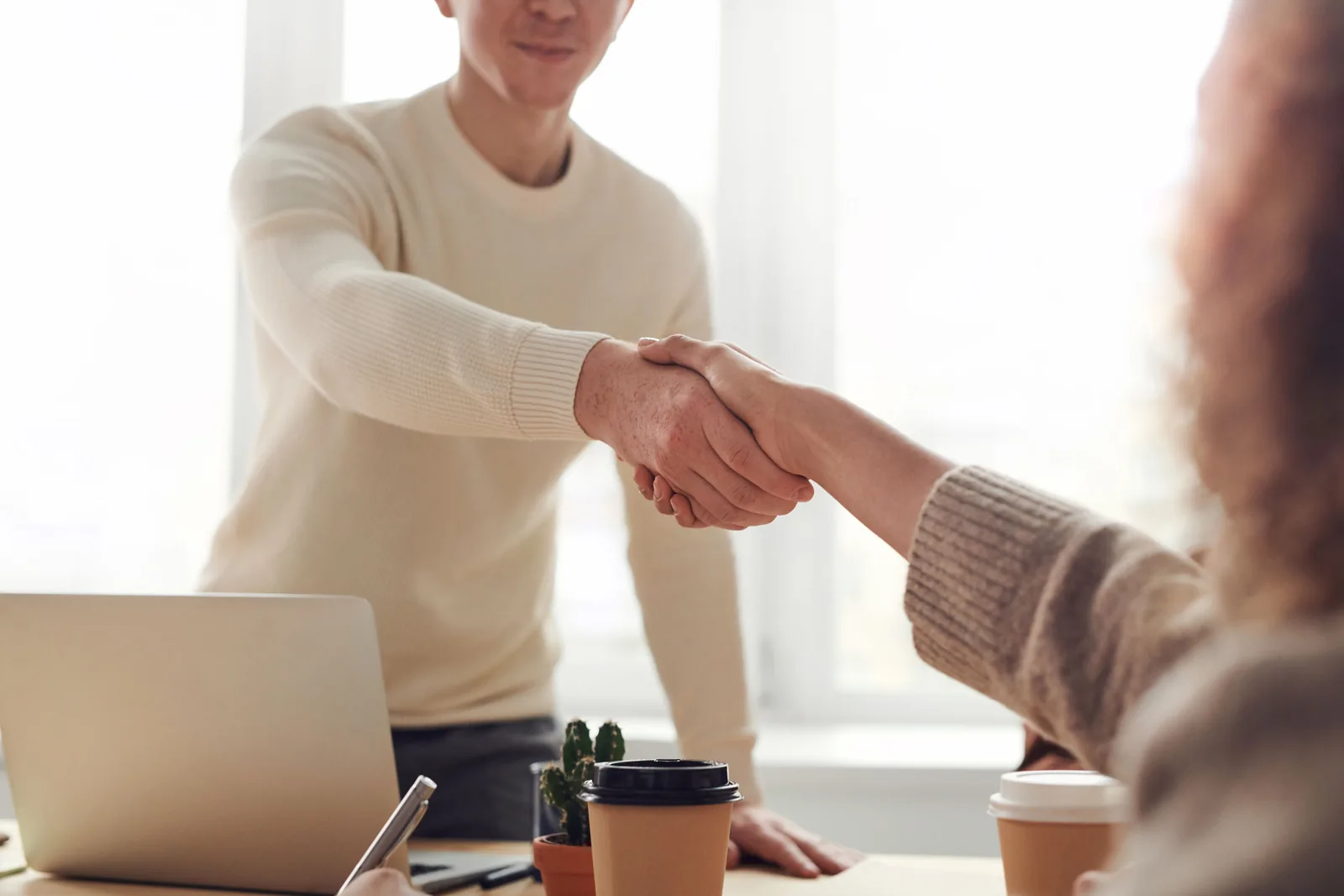 Professionals shaking hands after a business discussion.